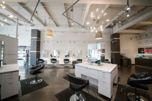 Best salon in Waukee and Urbandale interior with styling chairs, mirrors, product shelves; perfect for balayage, highlights, bridal hair.