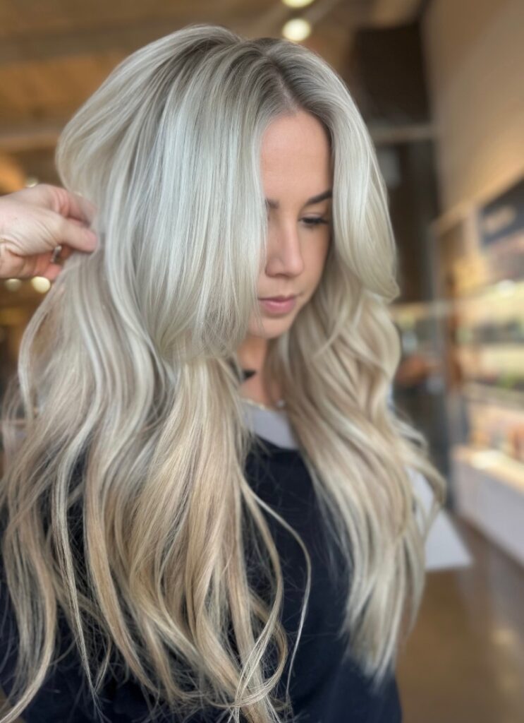 - Art of Life Salon & Spa at Urbandale and Waukee, IA A woman with long, wavy, platinum blonde balayage and highlights at the best salon in Waukee gets hair extensions for bridal hair. - Art of Life Salon & Spa at Urbandale and Waukee, IA