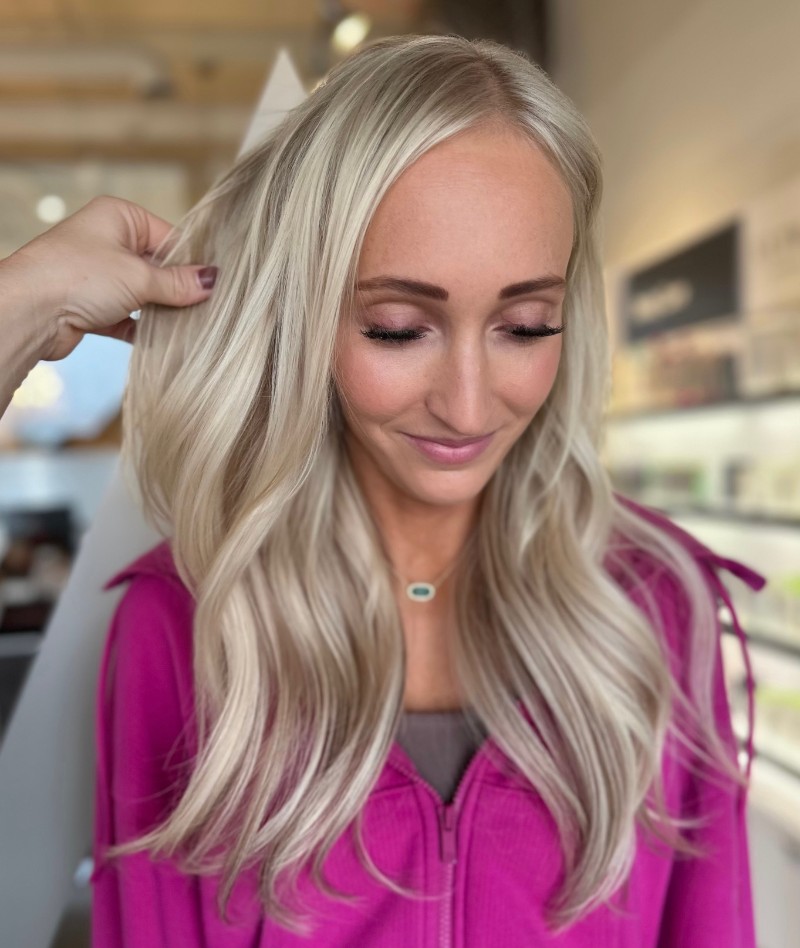 - Art of Life Salon & Spa at Urbandale and Waukee, IA A woman with long, wavy blonde hair—styled with balayage and highlights—smiles at the best salon in Waukee and Urbandale. - Art of Life Salon & Spa at Urbandale and Waukee, IA